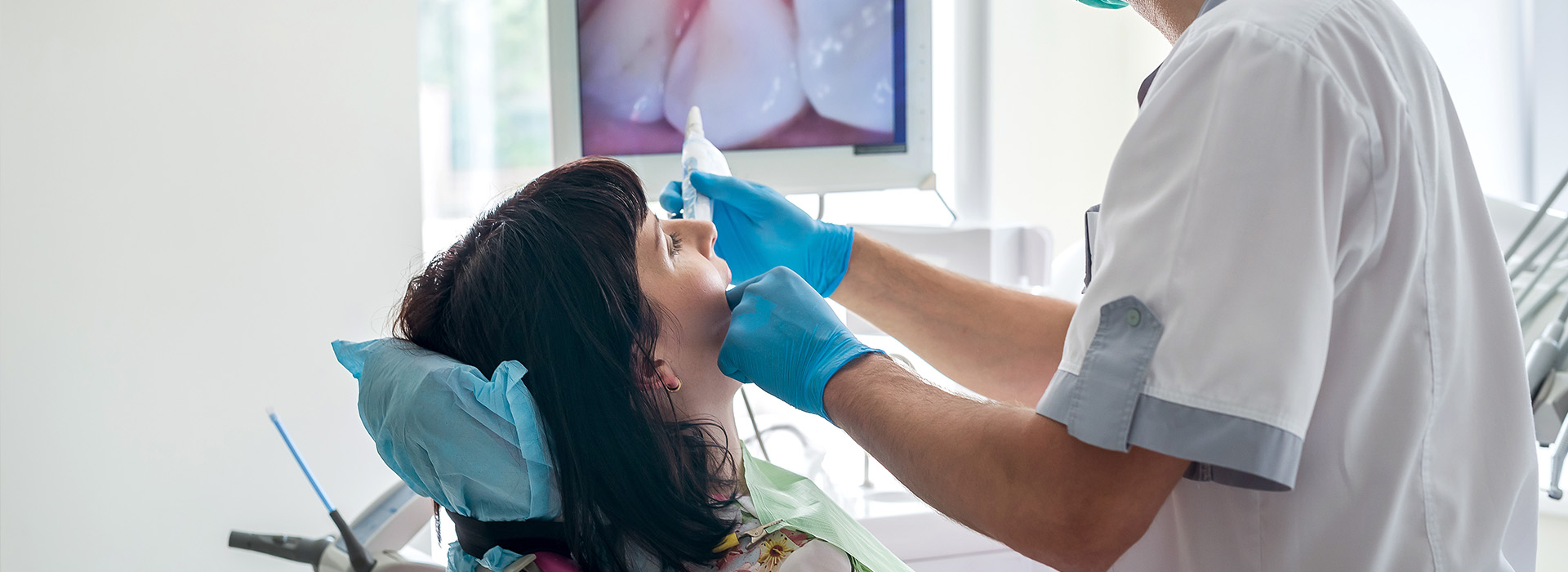 A dentist performing a dental procedure on a patient.