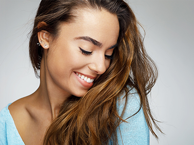 The image features two different photographs of a woman with long hair smiling at the camera. She s wearing a blue top, and there are no visible texts on the images.